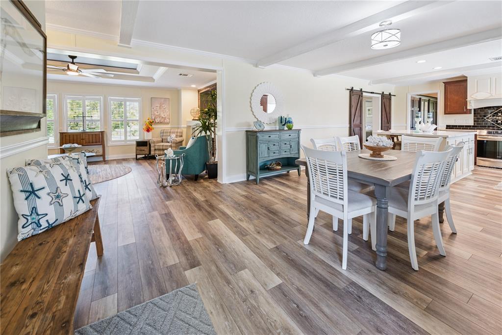 1175 Southwest 248th Avenue Steinhatchee, FL 32359 - Photo 24 of 54 a view of a dining room with furniture and wooden floor