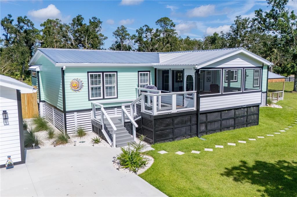 1175 Southwest 248th Avenue Steinhatchee, FL 32359 - Photo 3 of 54 a front view of house with yard outdoor seating and green space