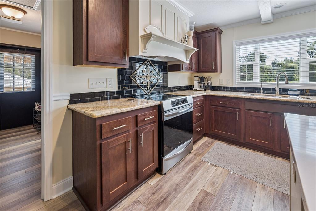 1175 Southwest 248th Avenue Steinhatchee, FL 32359 - Photo 31 of 54 a kitchen with a stove sink and cabinets