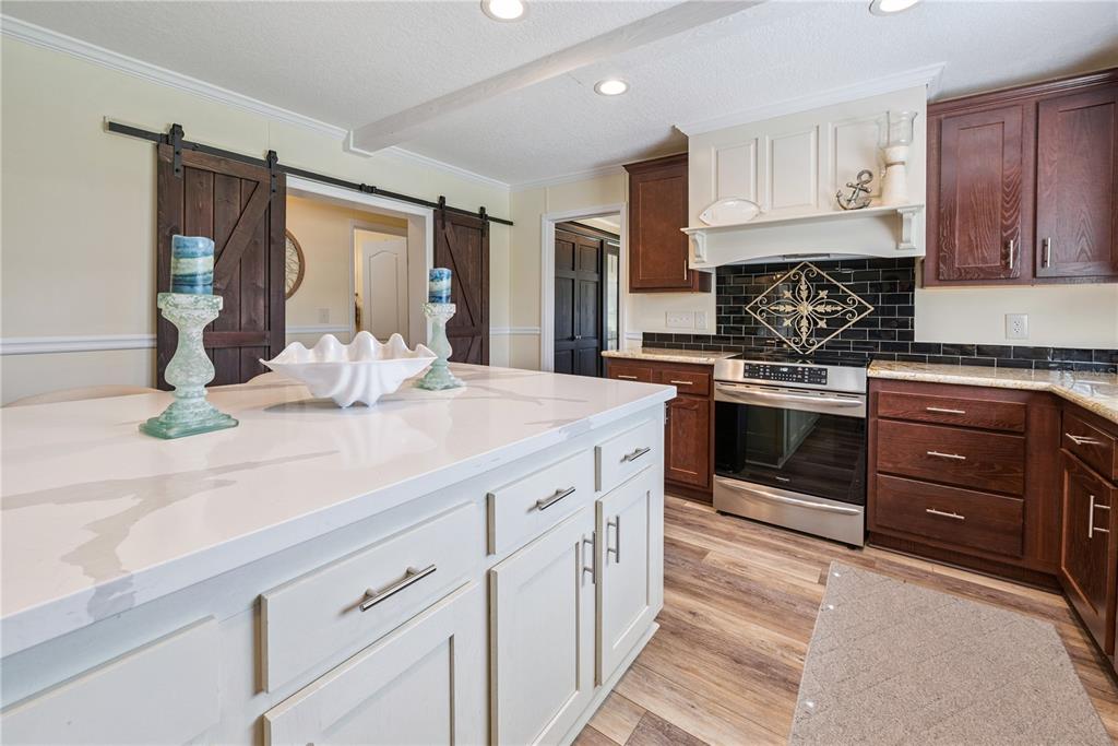 1175 Southwest 248th Avenue Steinhatchee, FL 32359 - Photo 32 of 54 a kitchen with kitchen island granite countertop a sink stove and cabinets