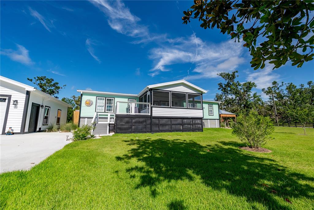 1175 Southwest 248th Avenue Steinhatchee, FL 32359 - Photo 4 of 54 a front view of a house with a yard