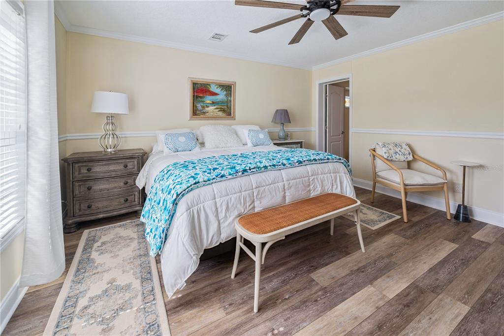1175 Southwest 248th Avenue Steinhatchee, FL 32359 - Photo 41 of 54 a bedroom with a bed and a chandelier