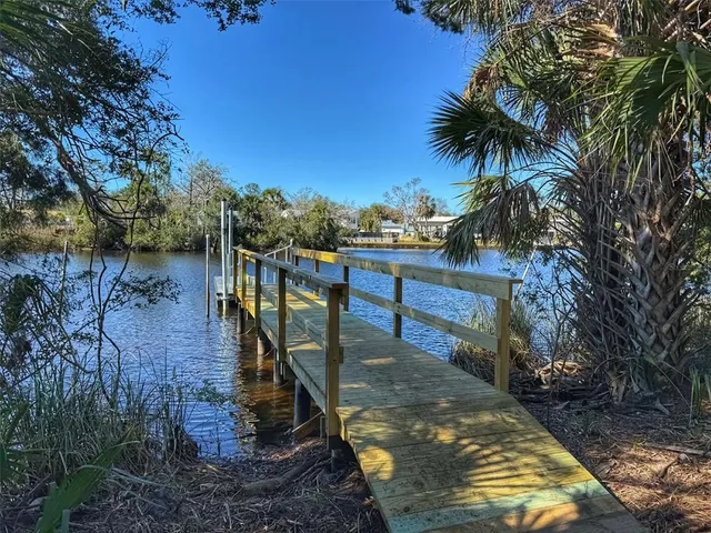 a view of a lake with houses in the back