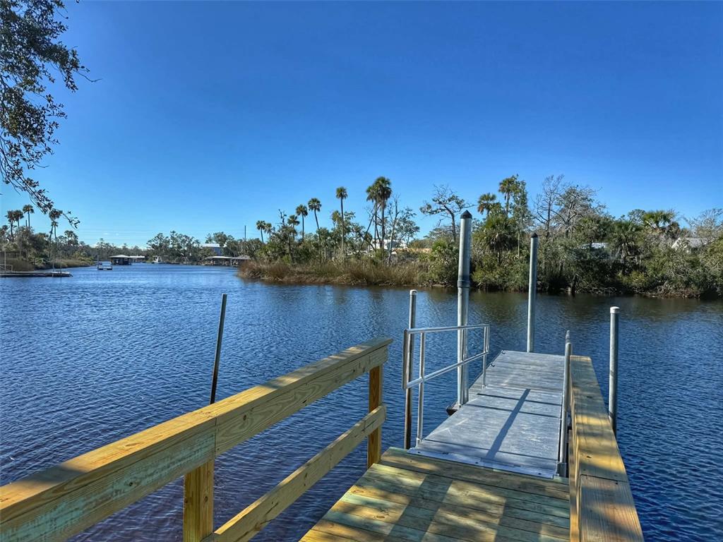 1175 Southwest 248th Avenue Steinhatchee, FL 32359 - Photo 52 of 54 a view of a balcony with wooden floor and lake view