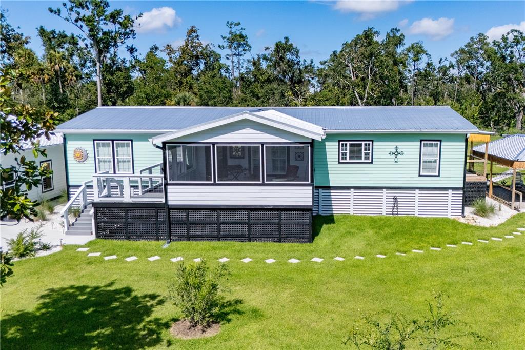 1175 Southwest 248th Avenue Steinhatchee, FL 32359 - Photo 7 of 54 a front view of a house with a garden
