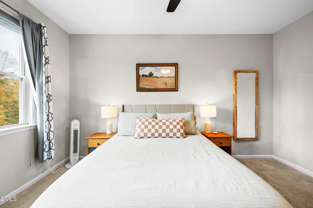 a bedroom with a large bed and a chandelier