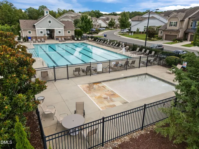 a view of a white house with a yard and furniture