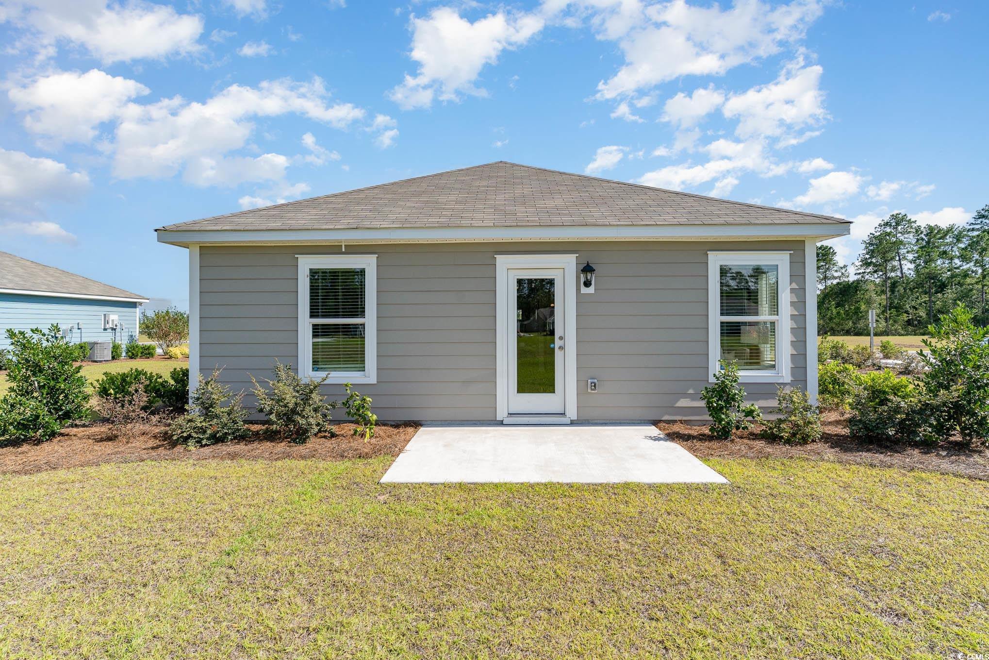 243 Teddy Bear Loop Conway, SC 29526 - Photo 2 of 24 Rear view of property with a patio, roof with shingles, and a lawn