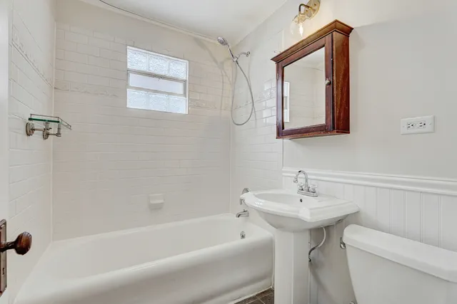 a bathroom with a sink a toilet and bathtub