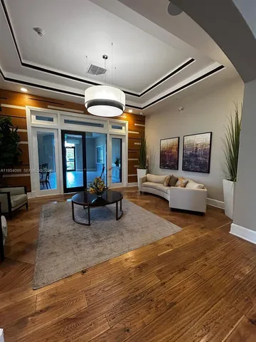 a living room with lots of furniture and kitchen view
