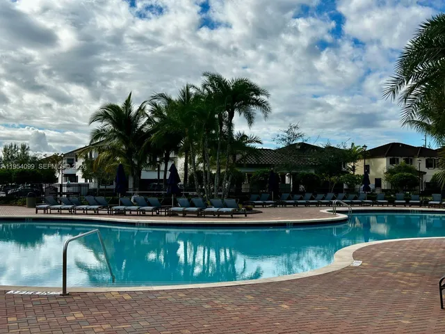 a living room with patio furniture and a large window