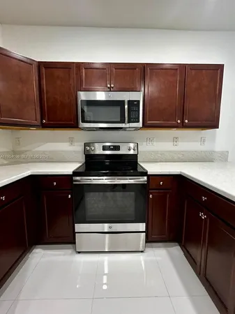 a kitchen with stainless steel appliances a sink and a stove