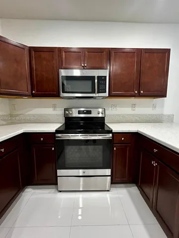 a kitchen with stainless steel appliances a sink and a stove
