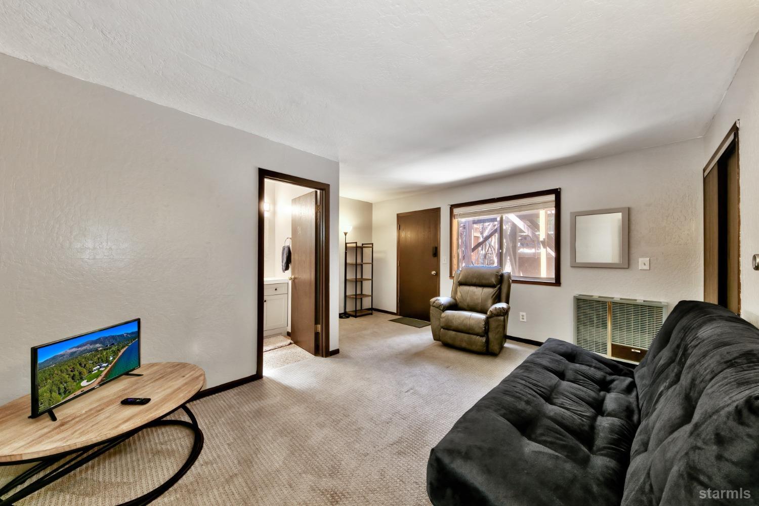 167 Tramway Drive, Unit B Stateline, NV 89449 - Photo 11 of 15 a living room with furniture and a window