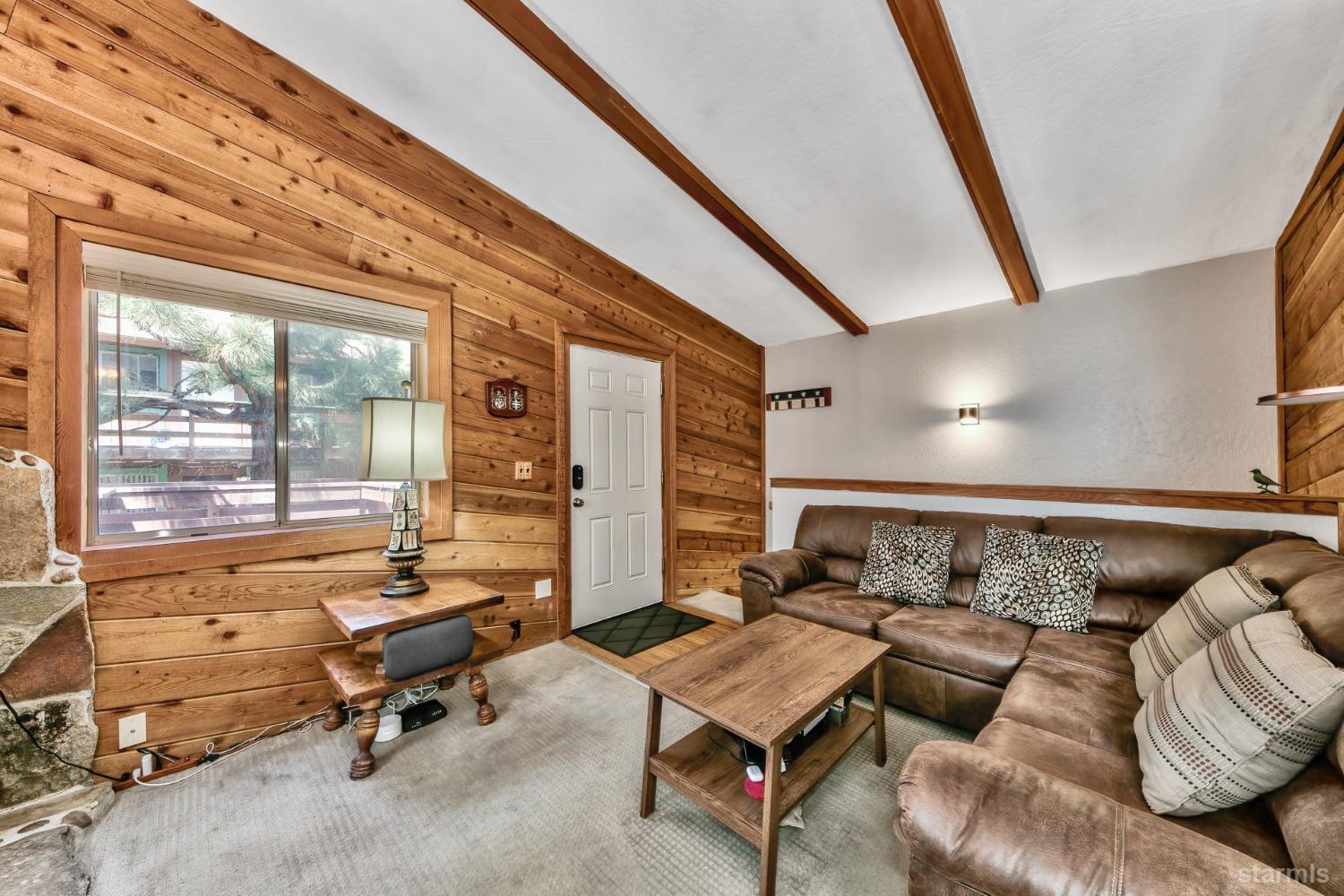 167 Tramway Drive, Unit B Stateline, NV 89449 - Photo 2 of 15 a living room with furniture and a floor to ceiling window