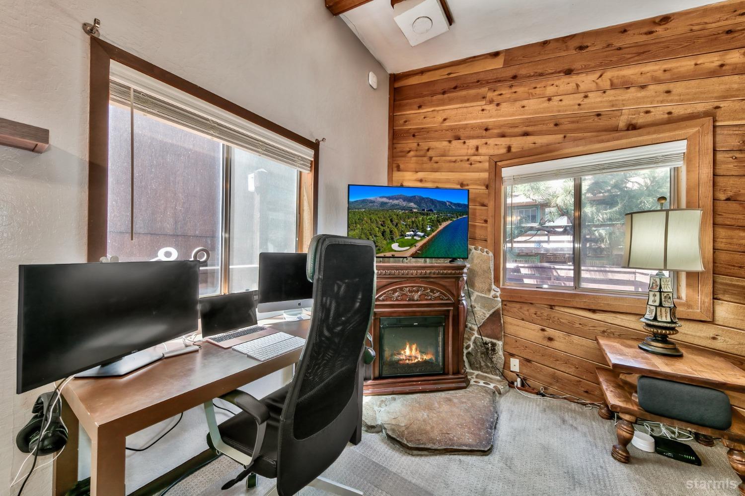 167 Tramway Drive, Unit B Stateline, NV 89449 - Photo 3 of 15 a work room with furniture and a flat screen tv