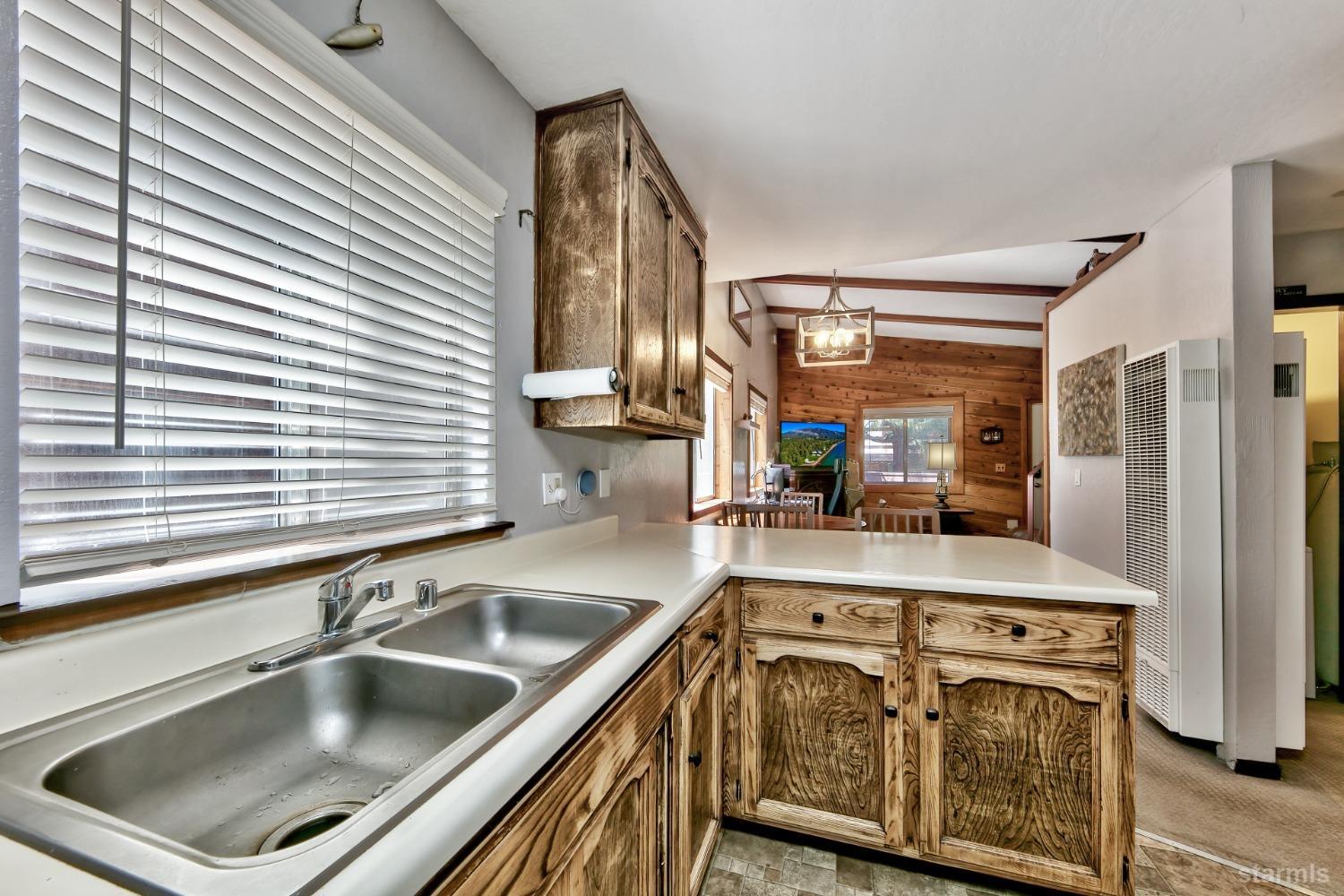 167 Tramway Drive, Unit B Stateline, NV 89449 - Photo 6 of 15 a kitchen with a sink stove and cabinets