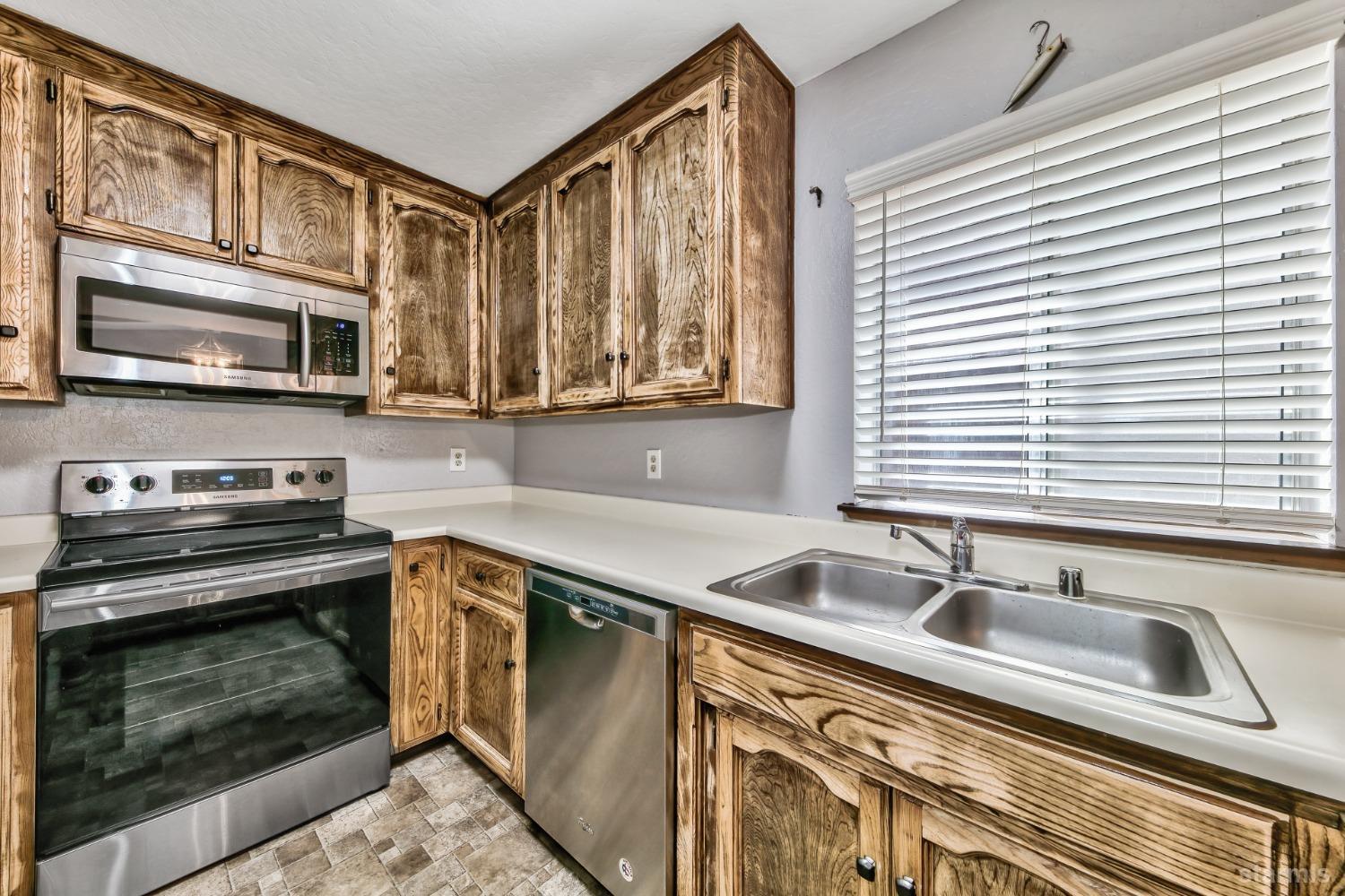 167 Tramway Drive, Unit B Stateline, NV 89449 - Photo 7 of 15 a kitchen with stainless steel appliances a stove sink and microwave