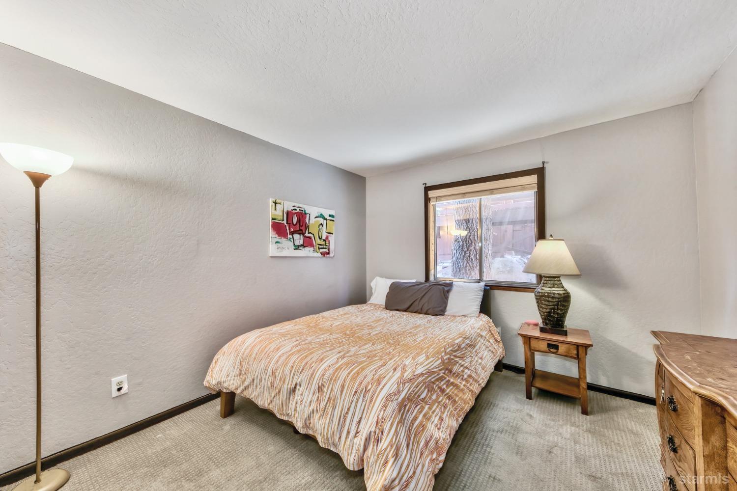 167 Tramway Drive, Unit B Stateline, NV 89449 - Photo 8 of 15 a bedroom with a bed and a window