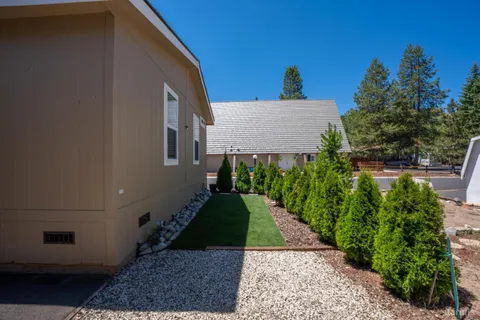 a view of an house with backyard space and garden
