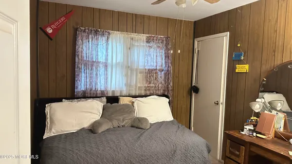 a bedroom with a bed and a mirror