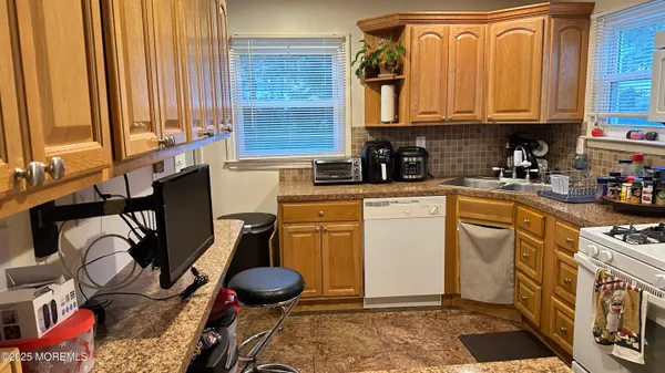 a kitchen with appliances cabinets and a window