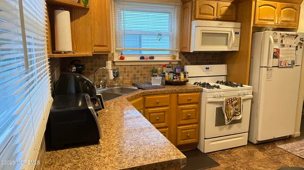 a kitchen with stainless steel appliances granite countertop a stove and a refrigerator