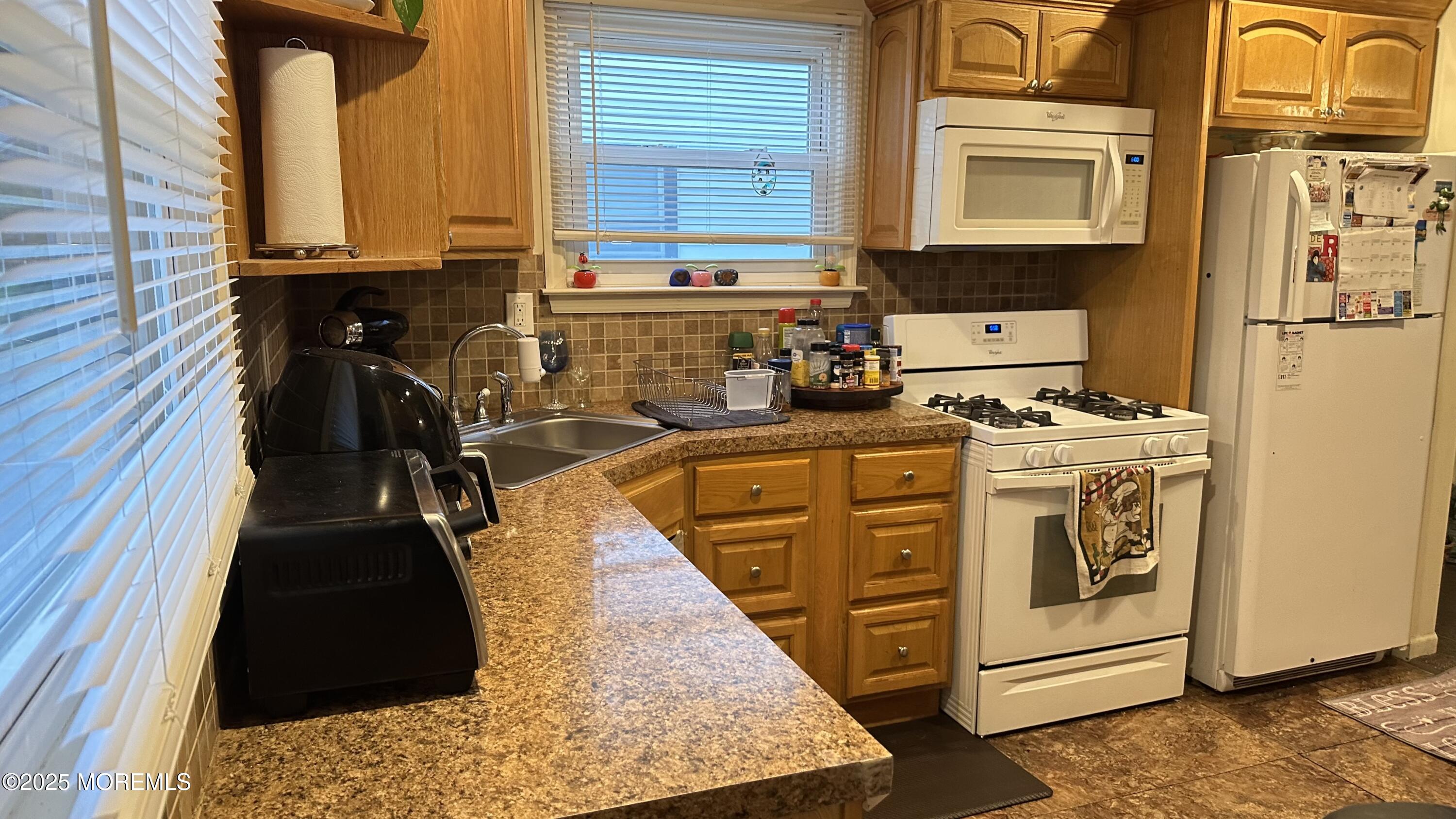 36 Liberty Street Freehold, NJ 07728 - Photo 5 of 20 a kitchen with stainless steel appliances granite countertop a stove and a refrigerator