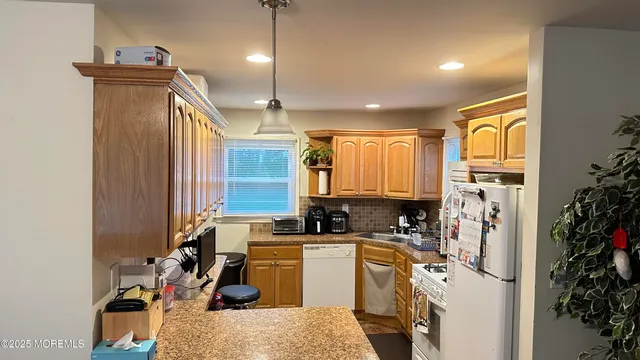 a kitchen with refrigerator a sink and a refrigerator