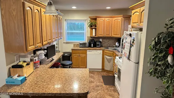 a view of a kitchen with appliances and cabinets