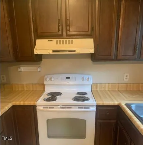 a kitchen with a stove and a sink