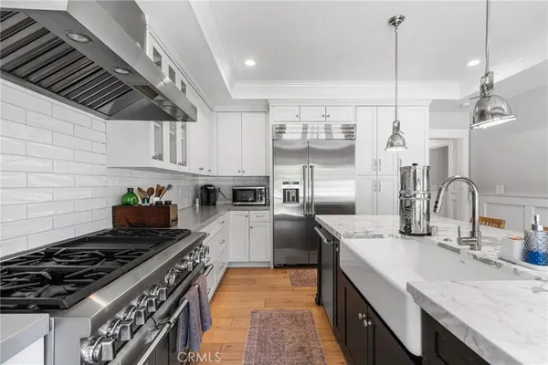 a kitchen with refrigerator and stove