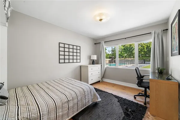 a bedroom with a bed and glass windows