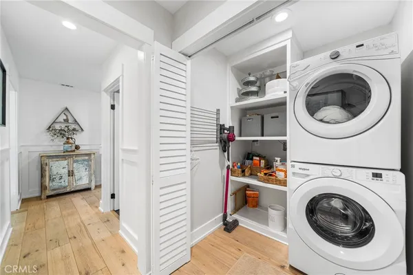 a view of a hallway with washer and dryer
