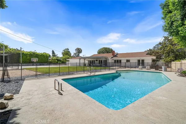 a view of a swimming pool with a yard