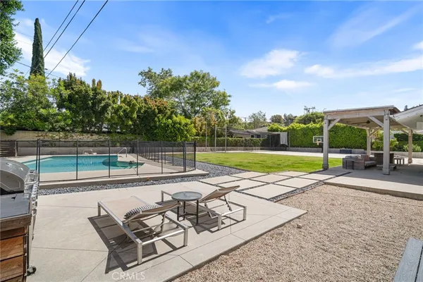 a view of a backyard with sitting area