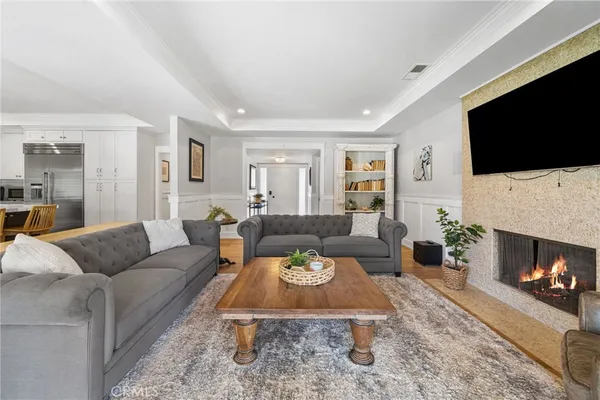 a living room with furniture a flat screen tv and a fireplace