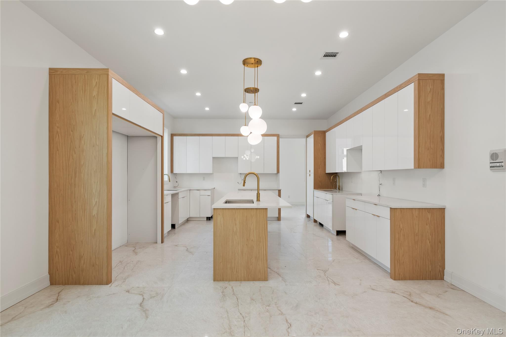 130 Union Road, Unit 201 Spring Valley, NY 10977 - Photo 9 of 47 a large kitchen with kitchen island white cabinets and stainless steel appliances