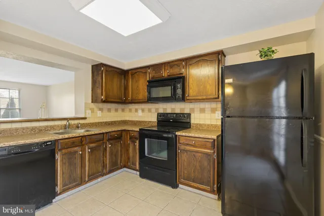 a kitchen with a sink stove and refrigerator