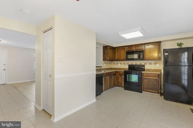 a kitchen with a refrigerator sink and microwave