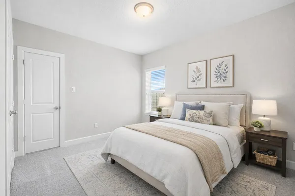 a bedroom with a bed and a window