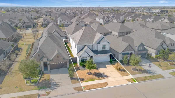 an aerial view of a backyard with table and chairs