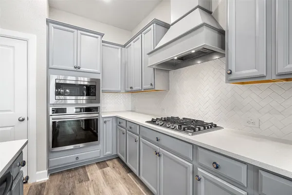 a kitchen with stainless steel appliances granite countertop a stove and a sink