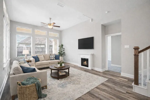 a living room with furniture a fireplace and a flat screen tv