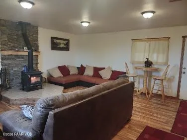 a bedroom with a chair and wooden floor