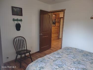 16432 Incline Trail Williams, AZ 86046 - Photo 23 of 62 a bedroom with a chair and wooden floor