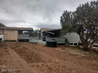 a view of a dry yard with trees