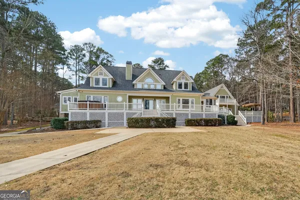 a living room with furniture a fireplace and a floor to ceiling window
