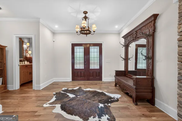 a kitchen with stainless steel appliances kitchen island granite countertop a refrigerator a stove and a wooden floors