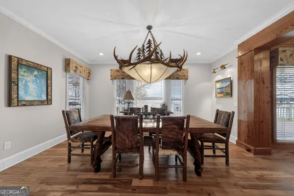 a view of a wooden deck with large trees